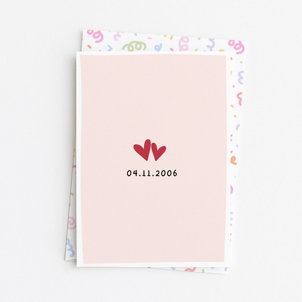 Close up of anniversary love date greeting card front design with envelope background